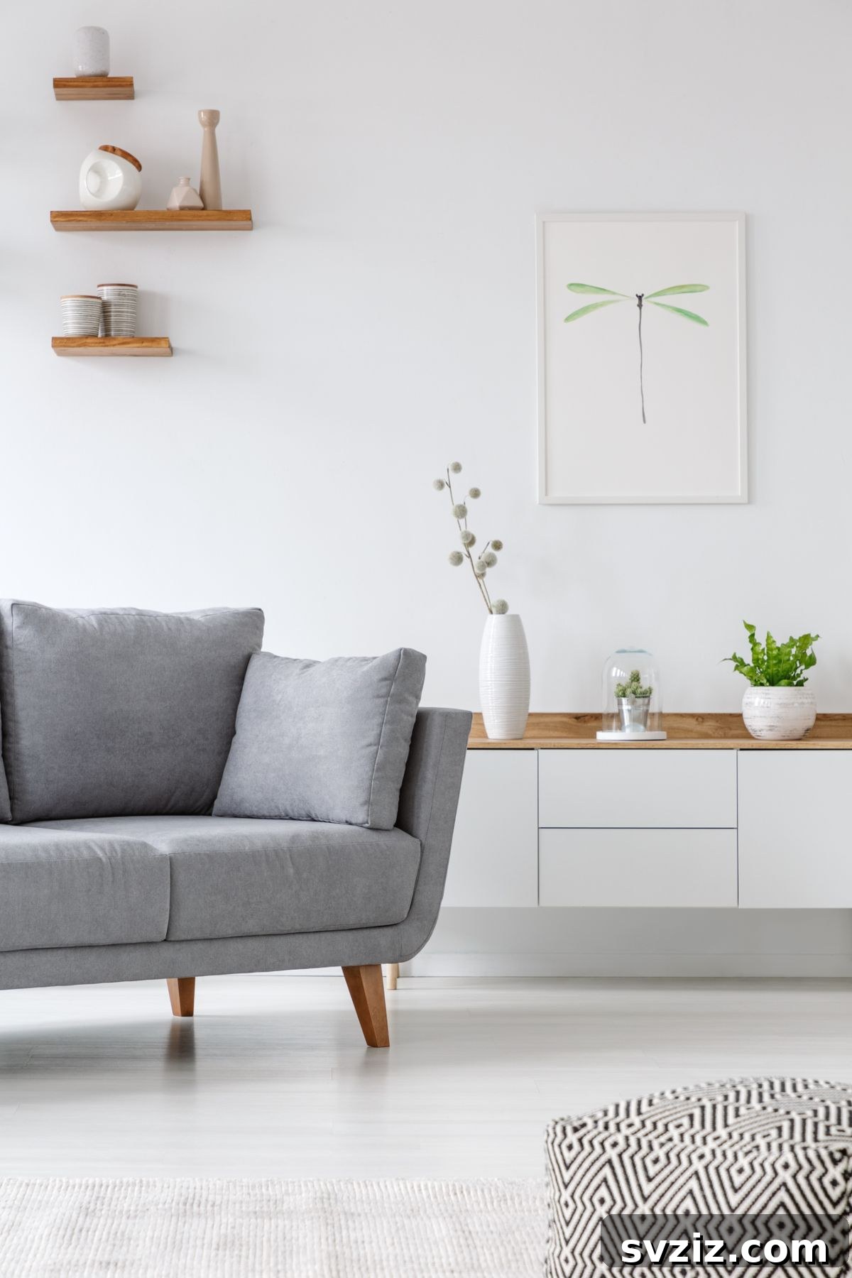 Three decorative vases arranged on a mantel or shelf above a sofa, showcasing varied textures