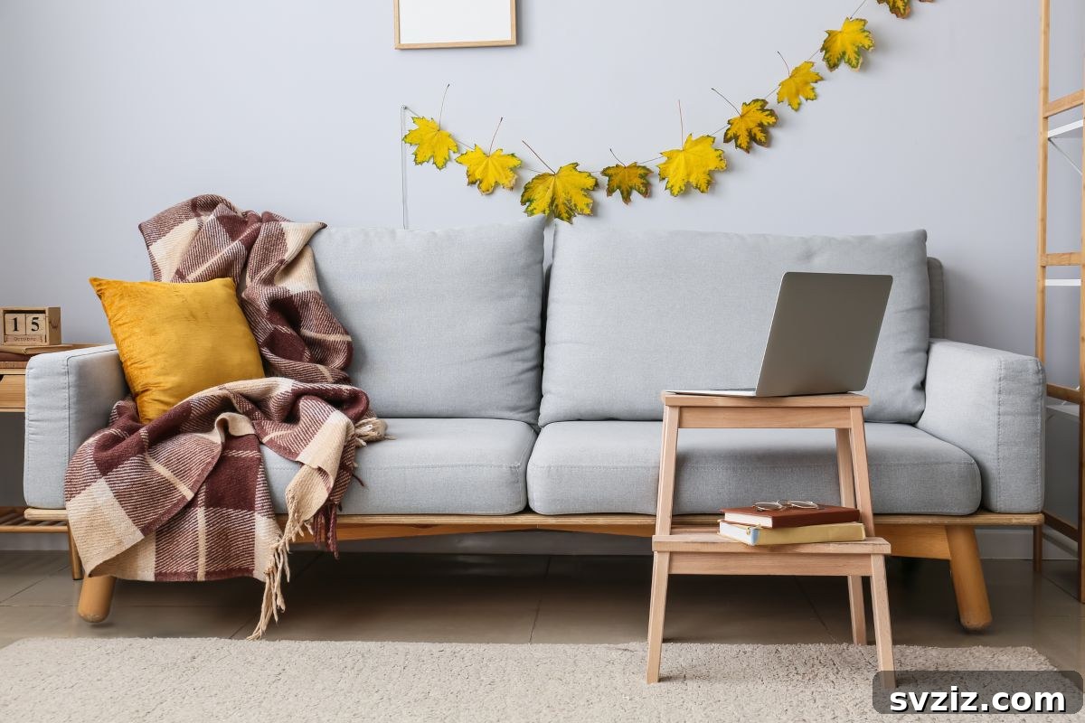 Beautiful autumn leaf garland hung above a sofa, bringing fall season colors indoors