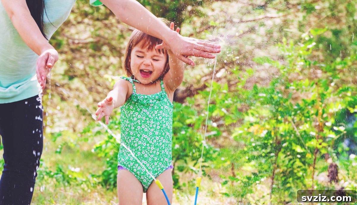 Happy Kids Running Through Backyard Sprinklers