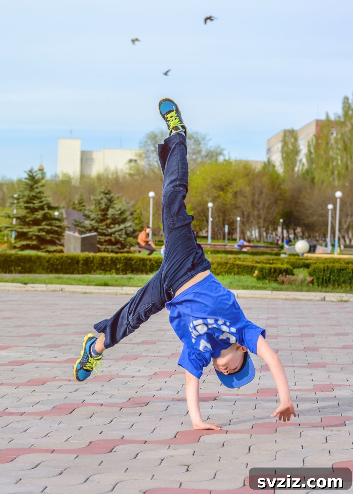 Child Practicing Cartwheels on a Grassy Lawn