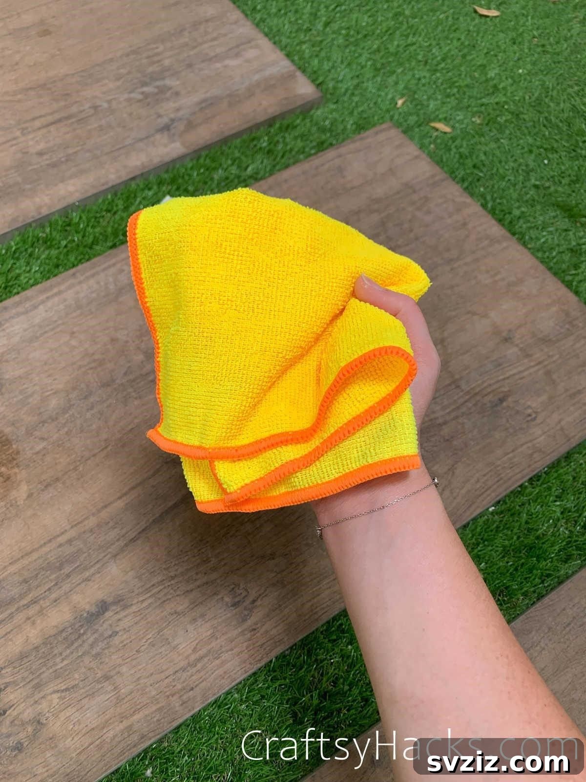 20 Game-Changing Cleaning Hacks to Reclaim Your Time 13 Person cleaning a window with a microfiber cloth