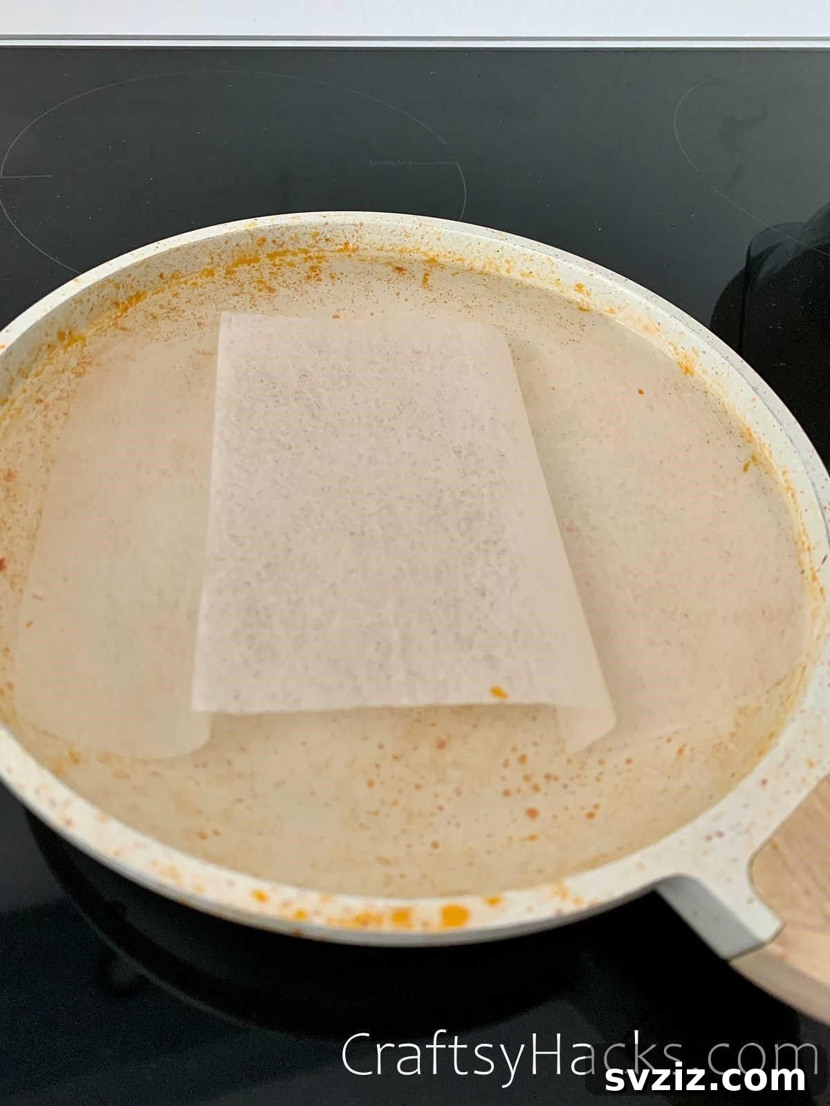 20 Game-Changing Cleaning Hacks to Reclaim Your Time 7 Dirty pot being cleaned with a dryer sheet