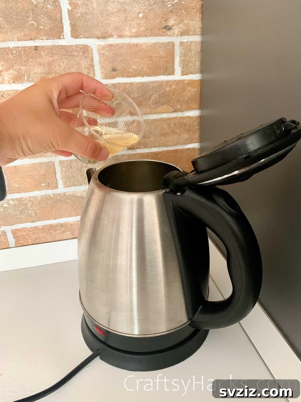 20 Game-Changing Cleaning Hacks to Reclaim Your Time 9 Kettle being descaled with white vinegar