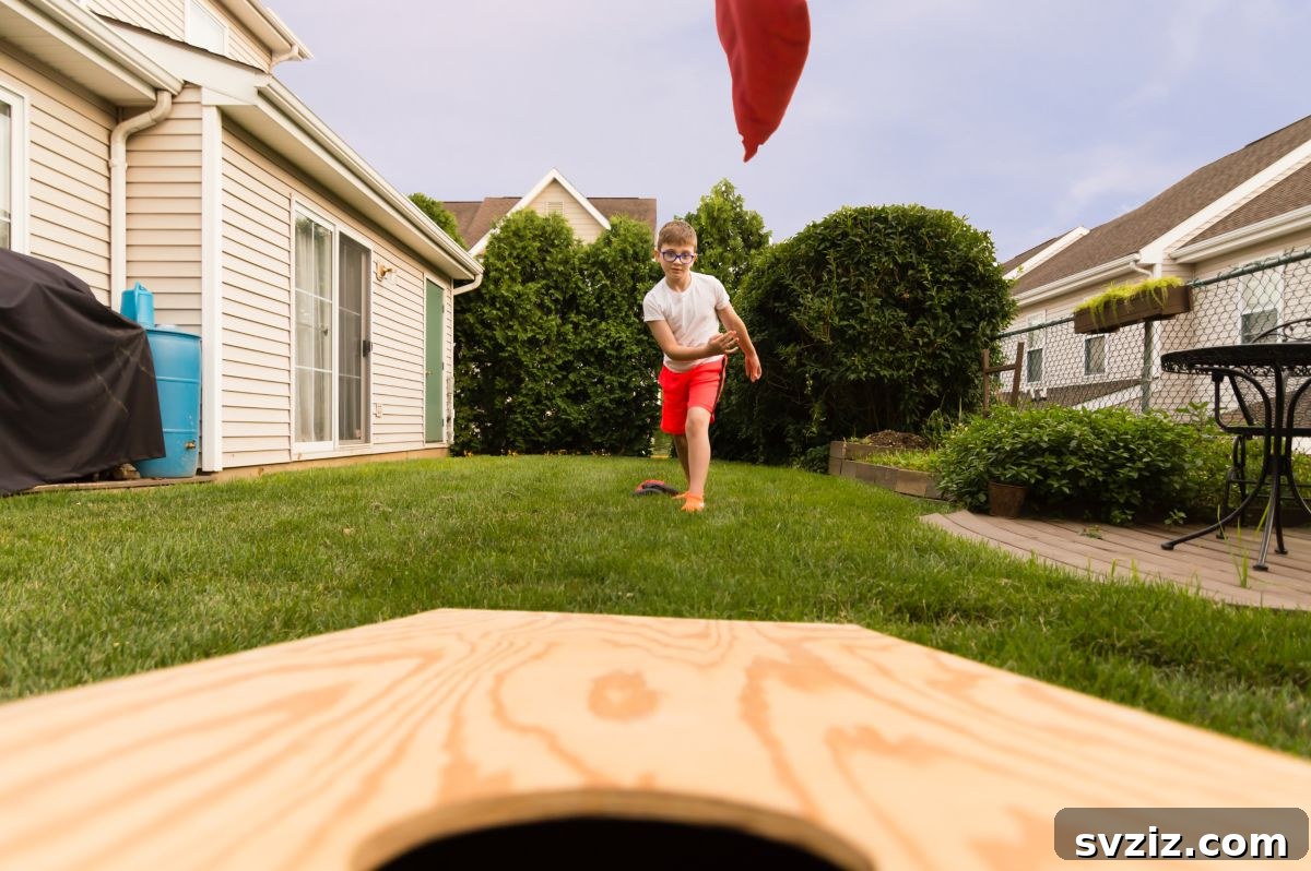 Little Explorers: 41 Outdoor Play Ideas for Preschoolers 19 Kids playing corn hole toss with colorful bean bags