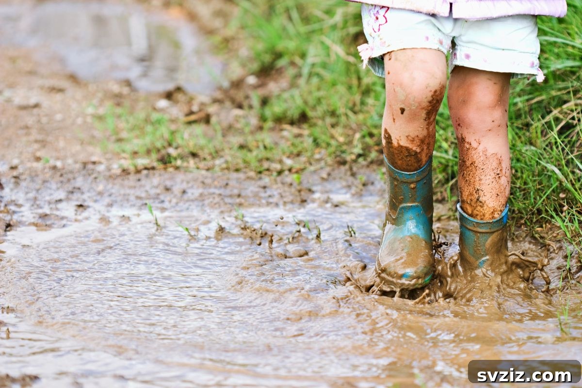 Little Explorers: 41 Outdoor Play Ideas for Preschoolers 25 Child practicing alphabet writing in a muddy sensory bin