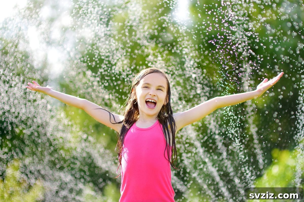 Kids playing in a sprinkler, enjoying a water game