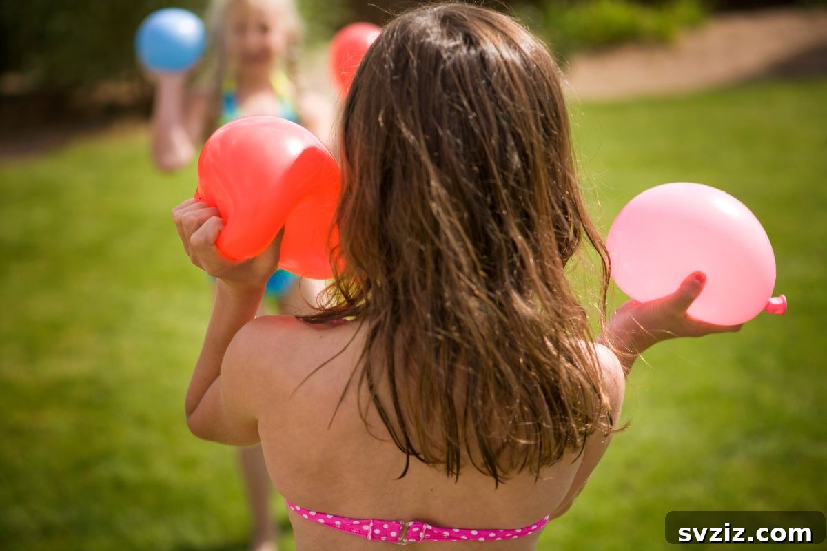 Kids engaged in water balloon painting outdoors