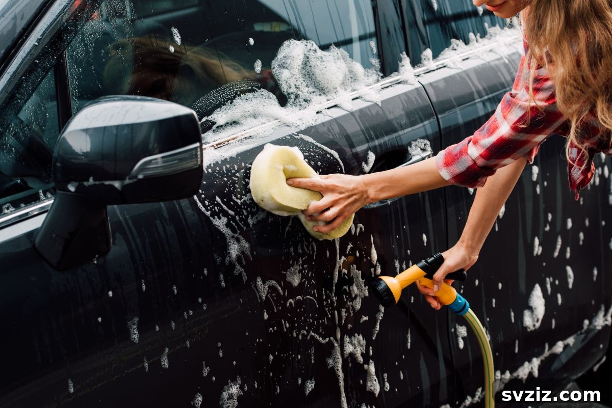 Teenager washing a car, learning maintenance skills