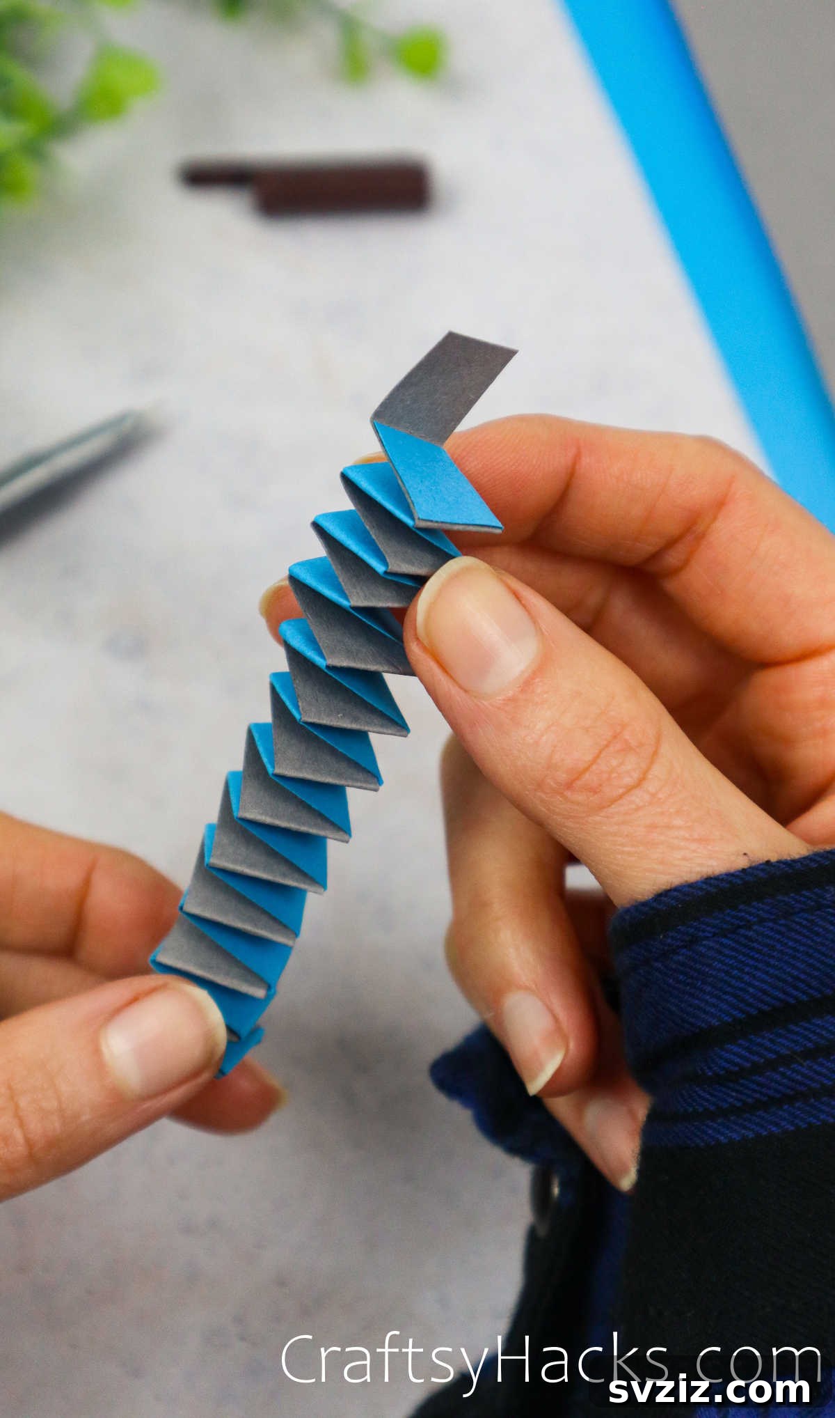 Spin a Web of Fun: Easy Paper Spider Craft 13 alternate strips of paper to create a spring