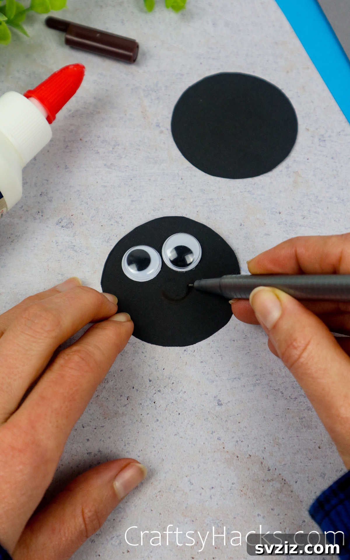 Spin a Web of Fun: Easy Paper Spider Craft 15 add eyes to the circle