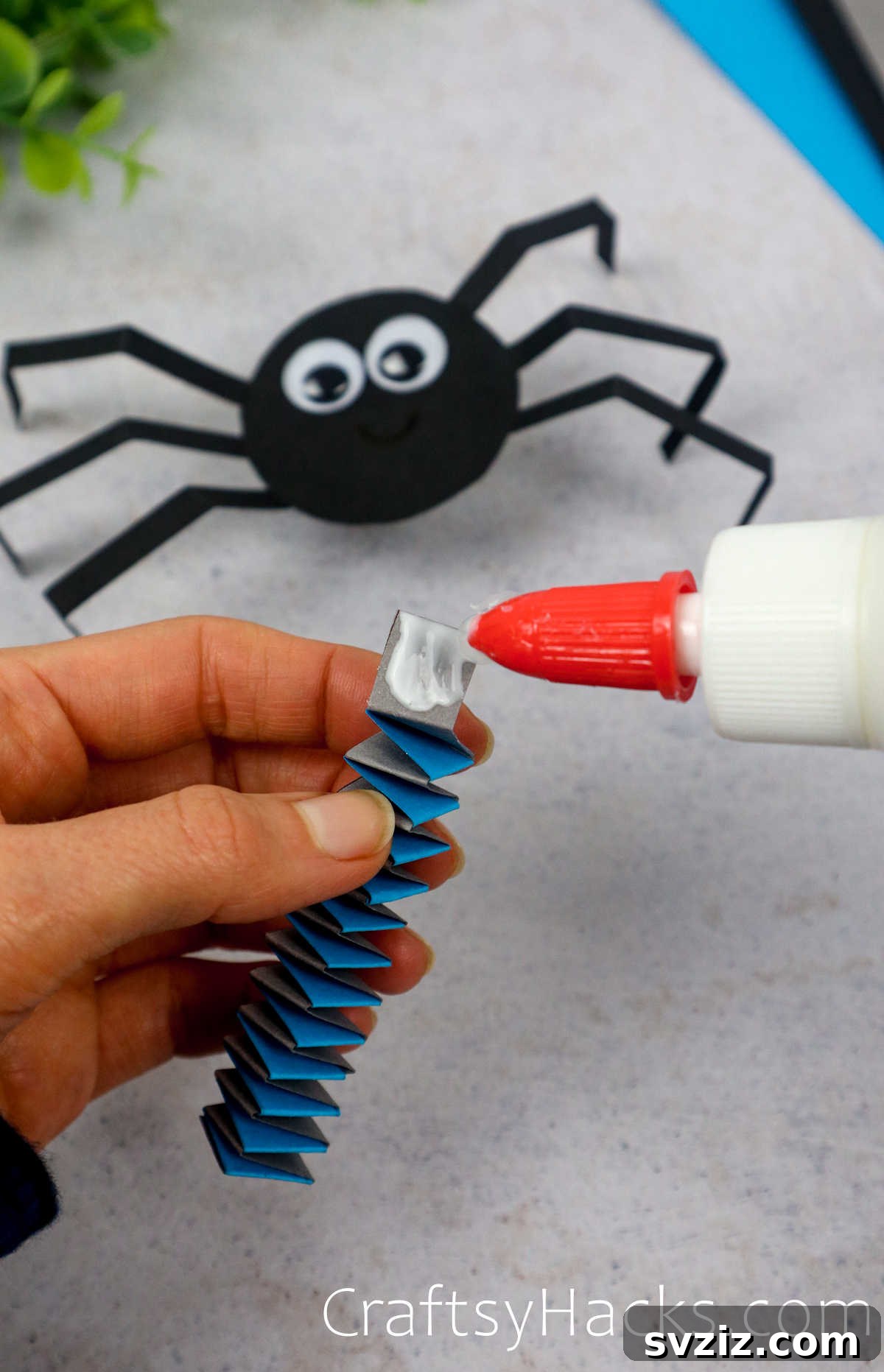 Spin a Web of Fun: Easy Paper Spider Craft 19 glue spring onto back of spider