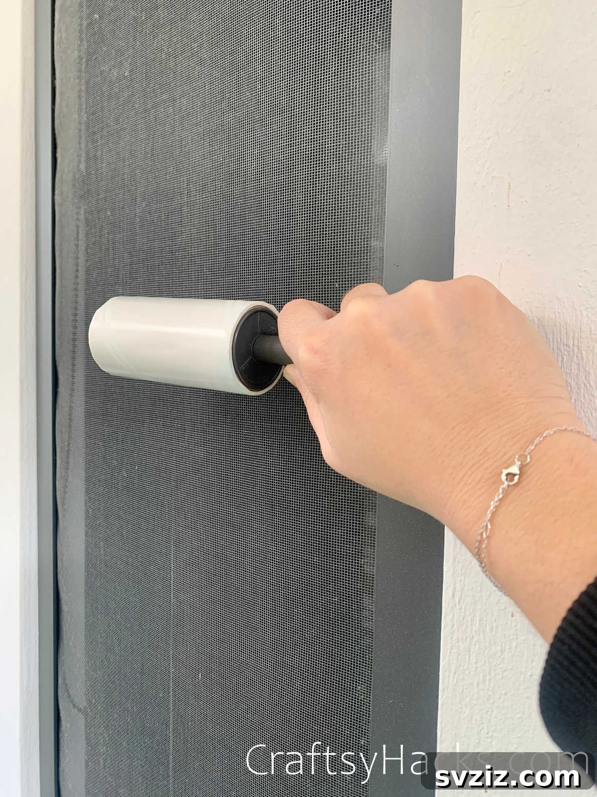 clean window screens with lint roller