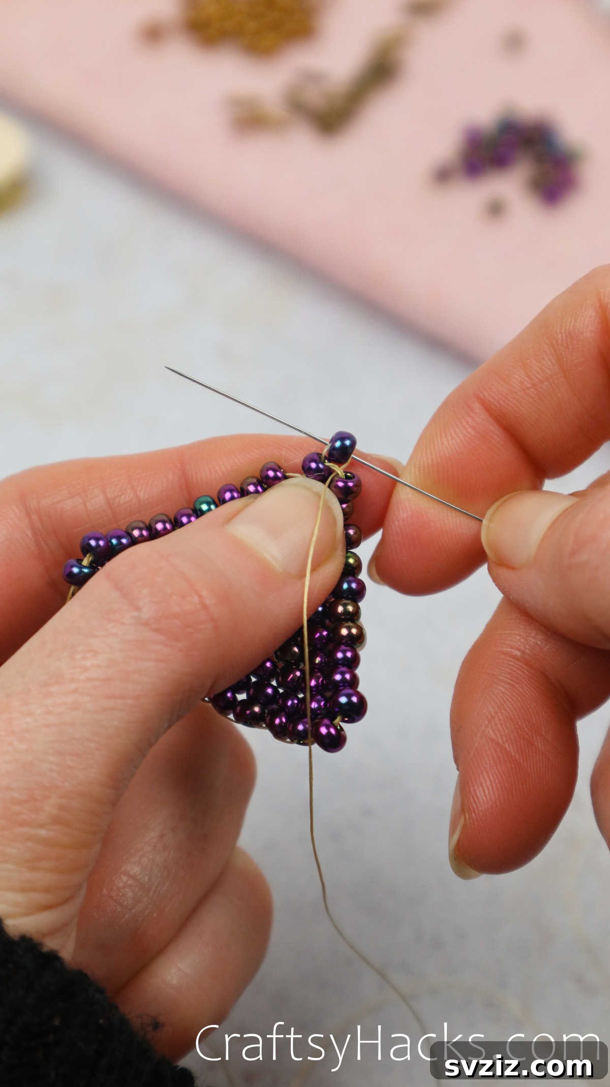 Craft Your Own Beaded Earrings 40 Needle adding the very last bead to complete the triangle design.