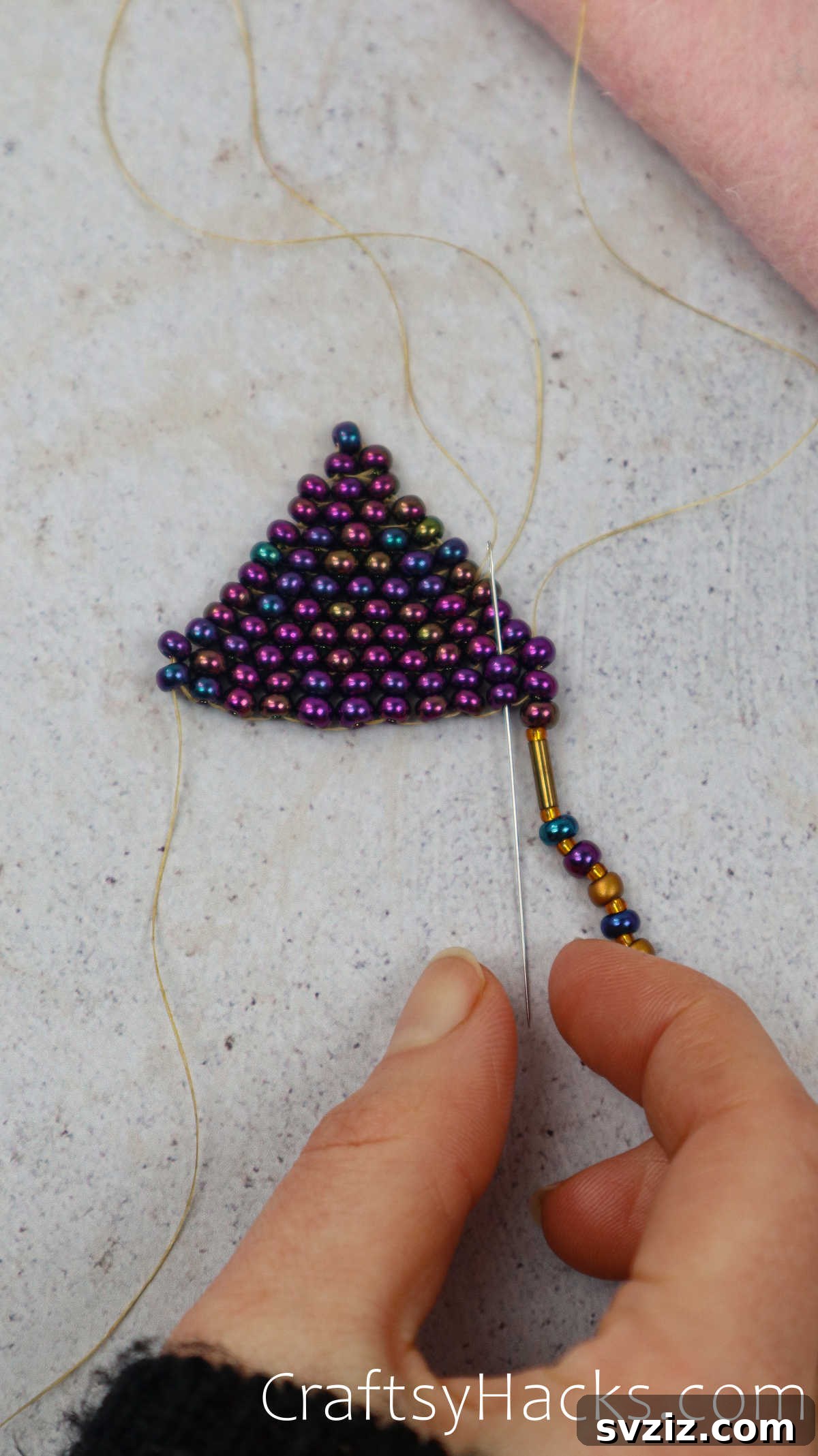 Craft Your Own Beaded Earrings 52 Needle poking through a hole to begin the second line of fringe.