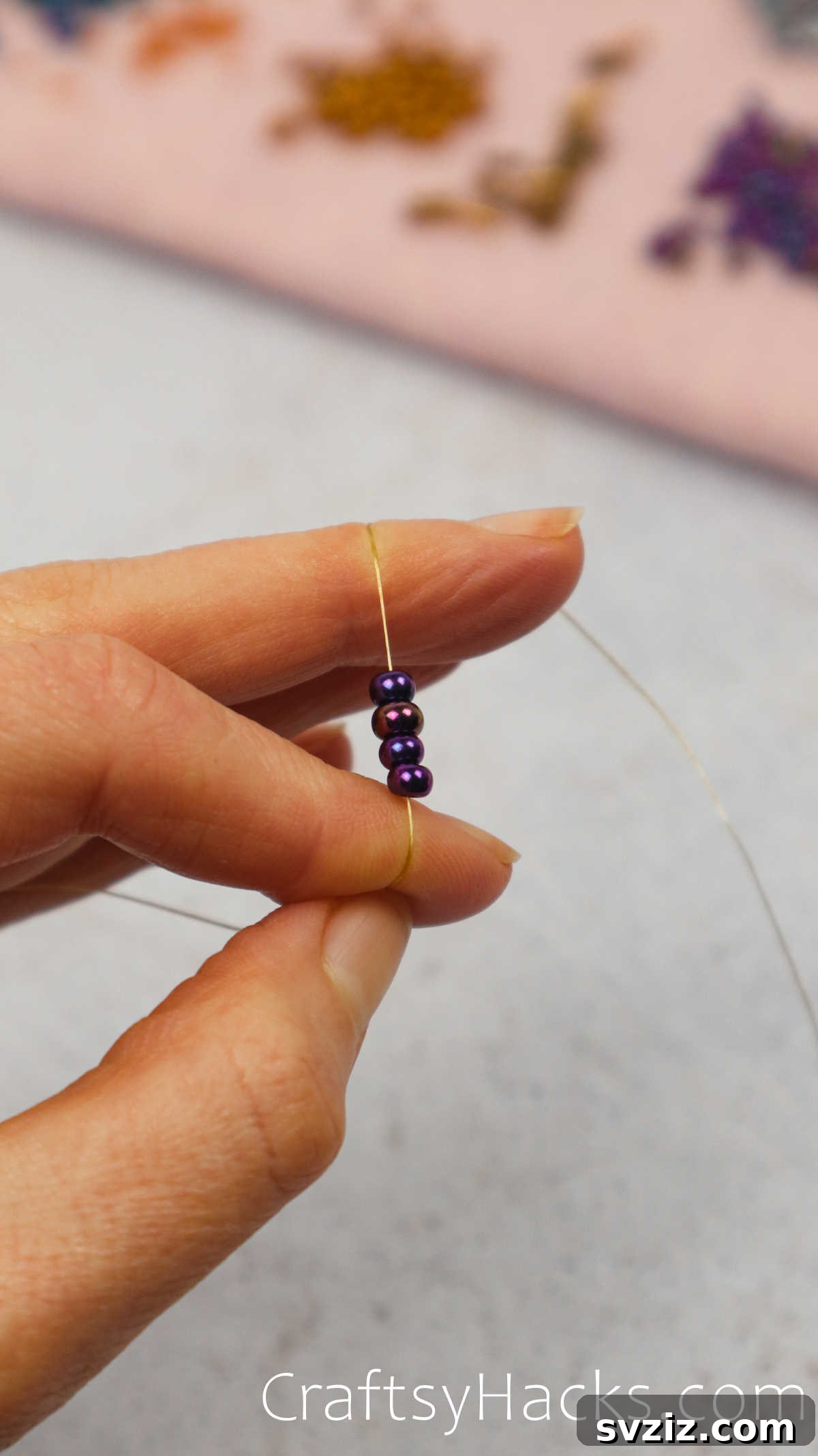 Craft Your Own Beaded Earrings 8 Four seed beads positioned on beading thread, forming the initial loop.