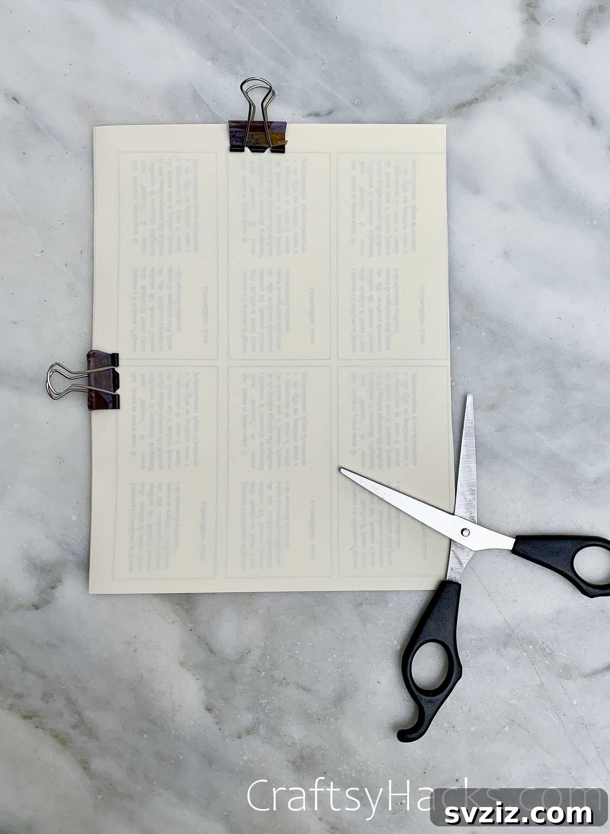 Binder clips holding a stack of papers together for precise cutting
