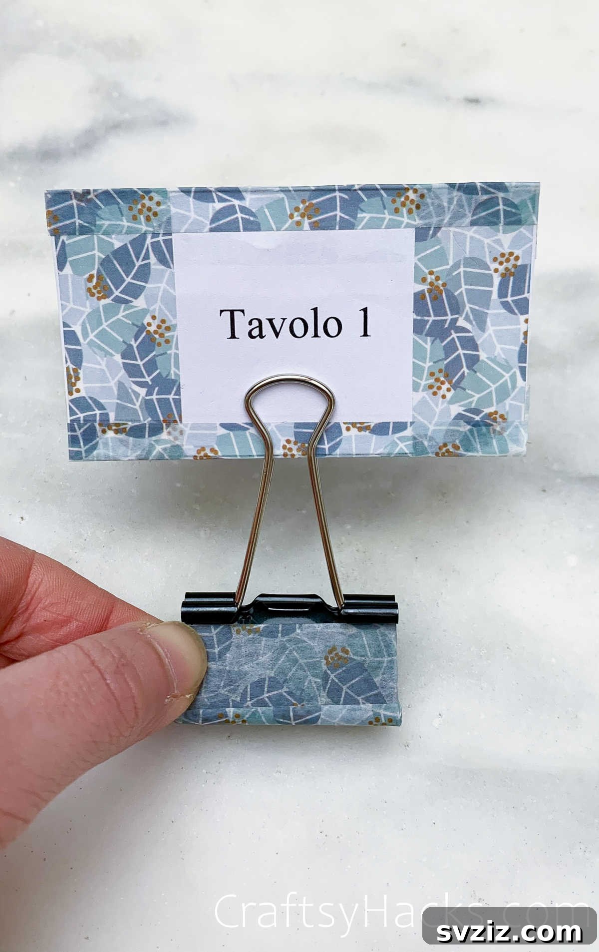 Binder clips repurposed as table number sign holders for events