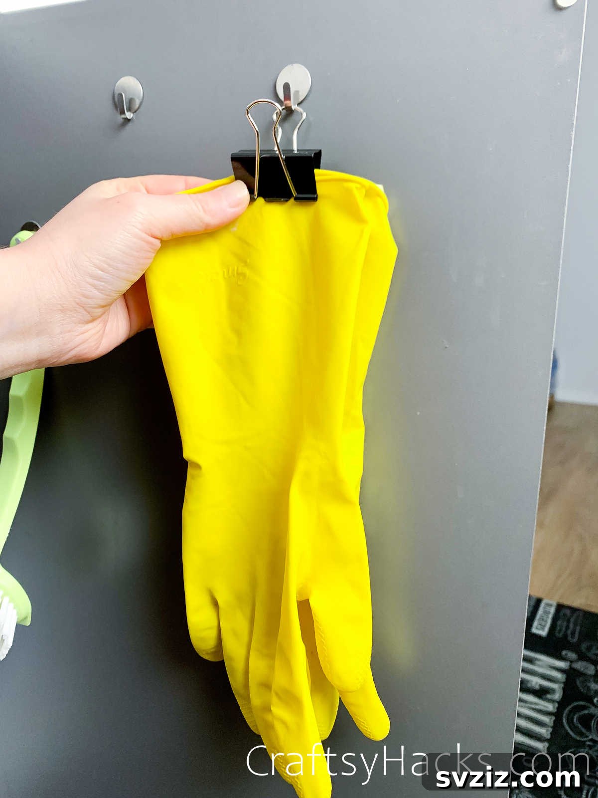 Hanging gloves with binder clips on a hook for drying and storage
