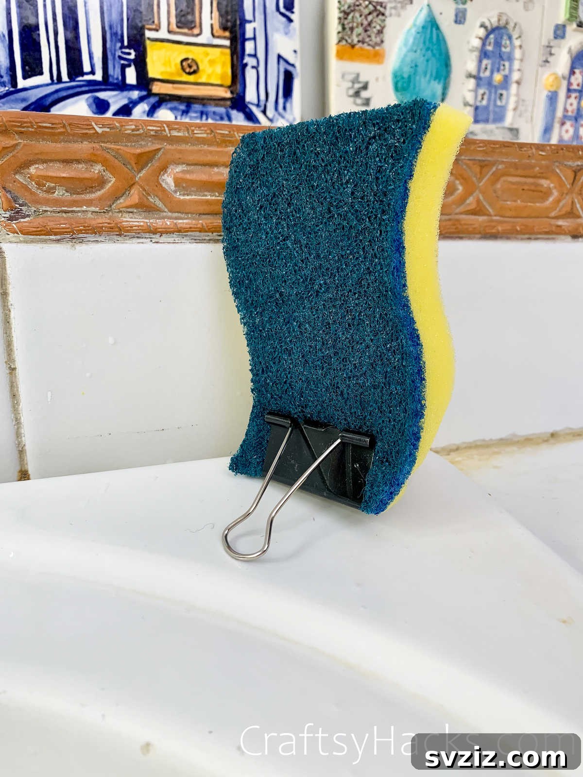 Binder clip holding a kitchen sponge upright to air dry quickly