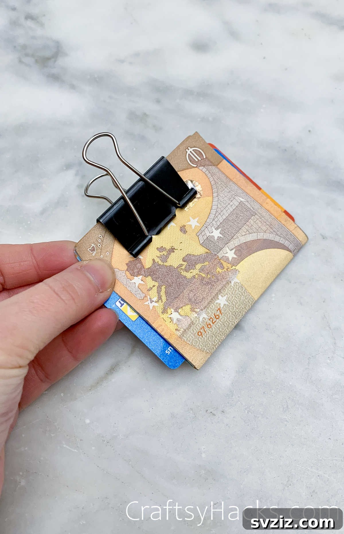 Binder clip used as a minimalist money and card holder