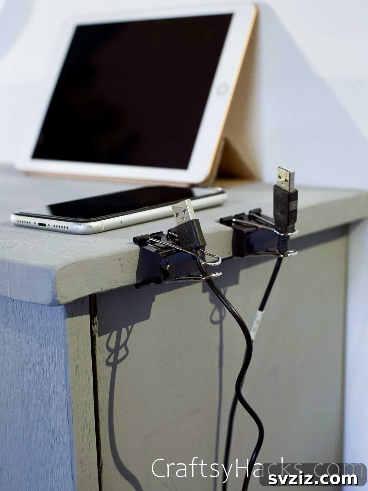 Organizing loose cables with binder clips attached to a desk