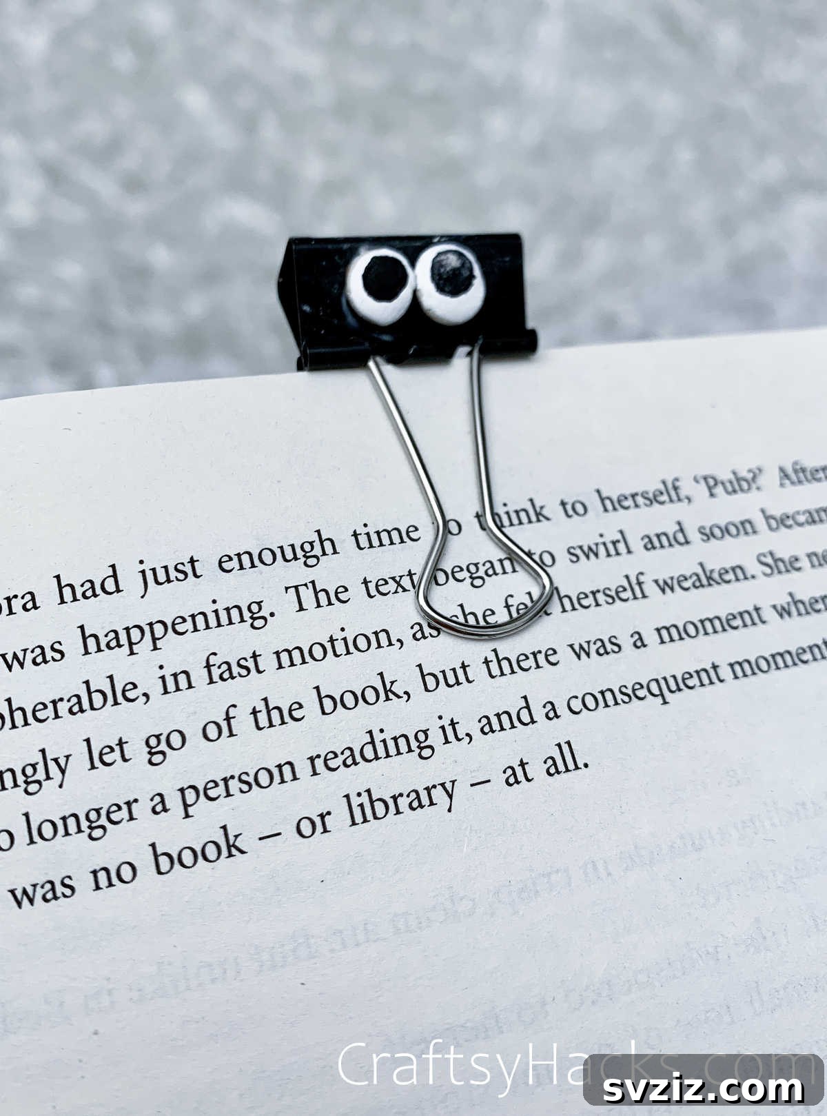 Binder clip bookmark decorated with googly eyes