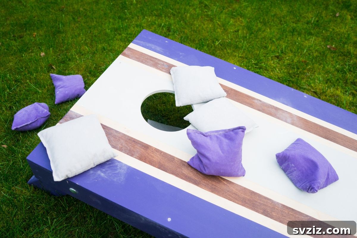 Two cornhole boards set up in a backyard