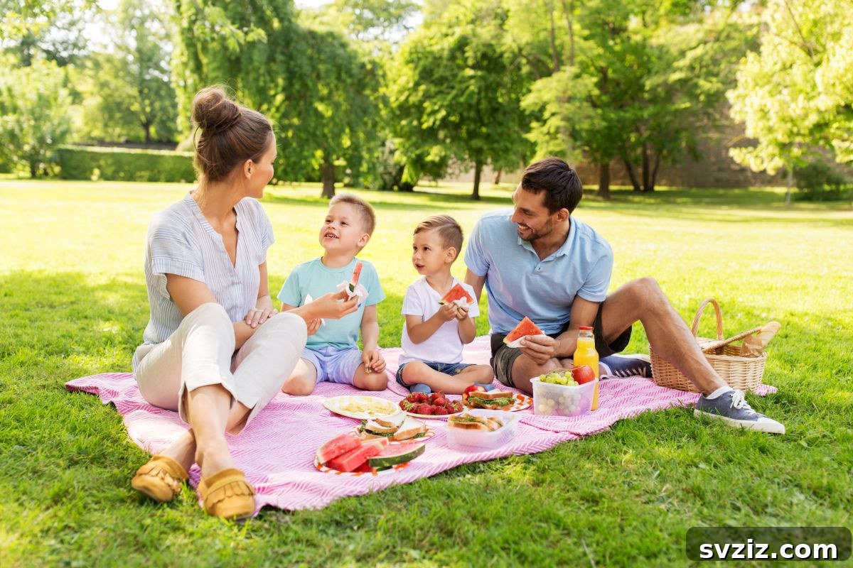 Family having a picnic on a blanket in the backyard