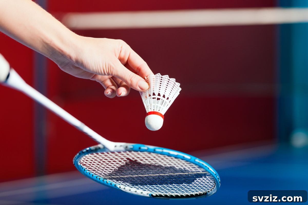 People playing badminton in a backyard