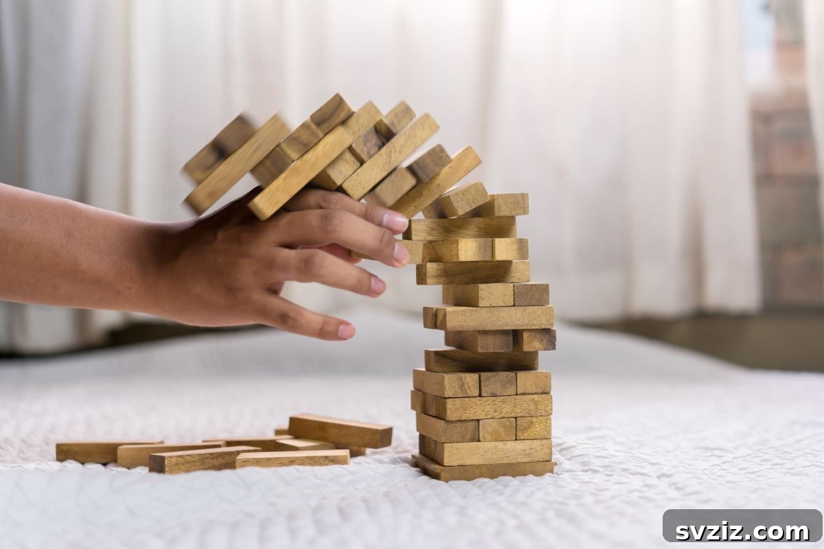 Giant Jenga tower in a backyard with a family playing
