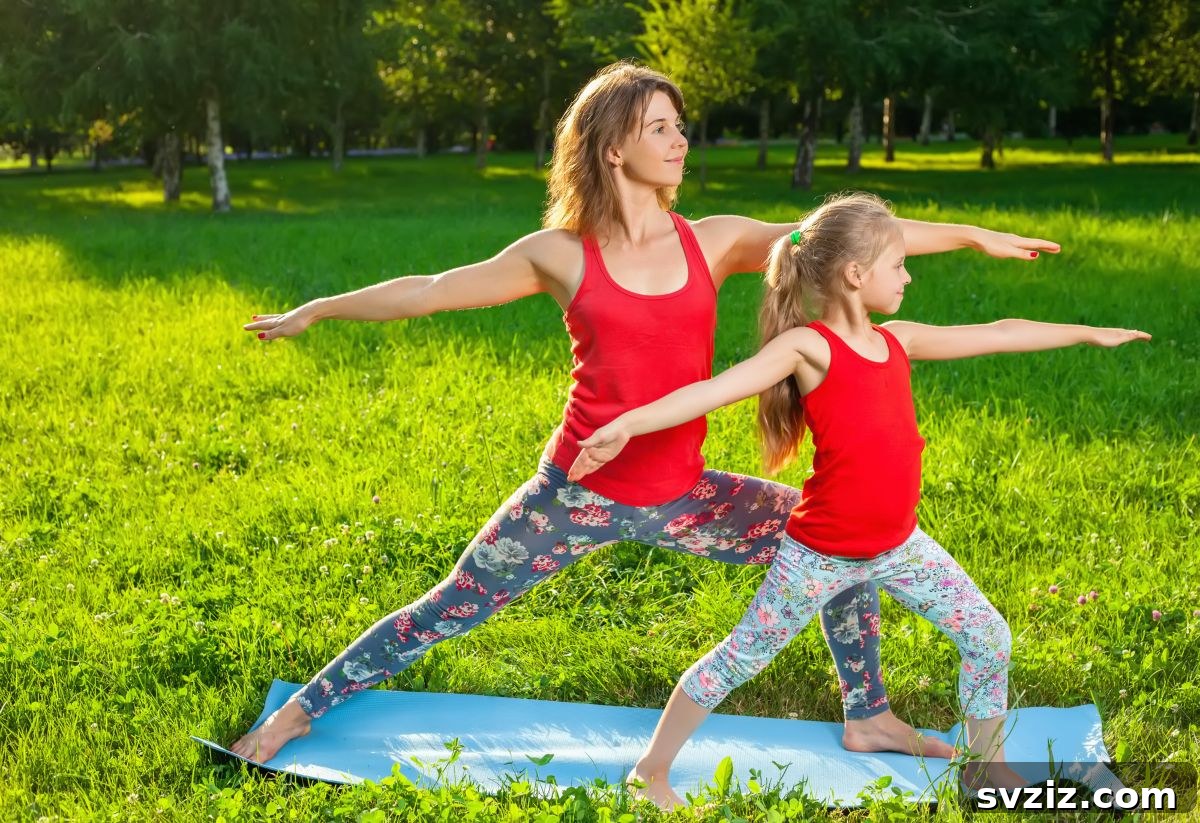 Family doing yoga poses on a grassy lawn