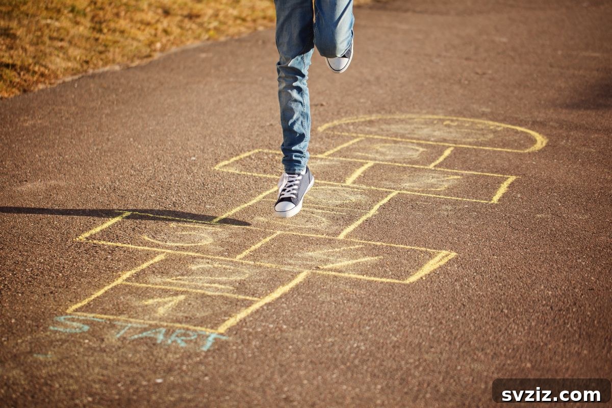 Child playing hopscotch drawn with chalk