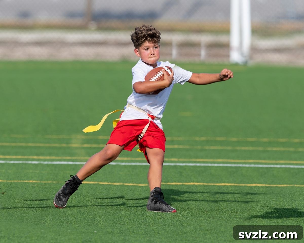 Kids playing flag football in a grassy backyard