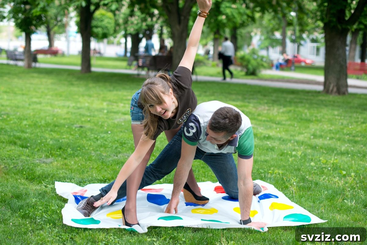 Family playing giant Twister on a green lawn