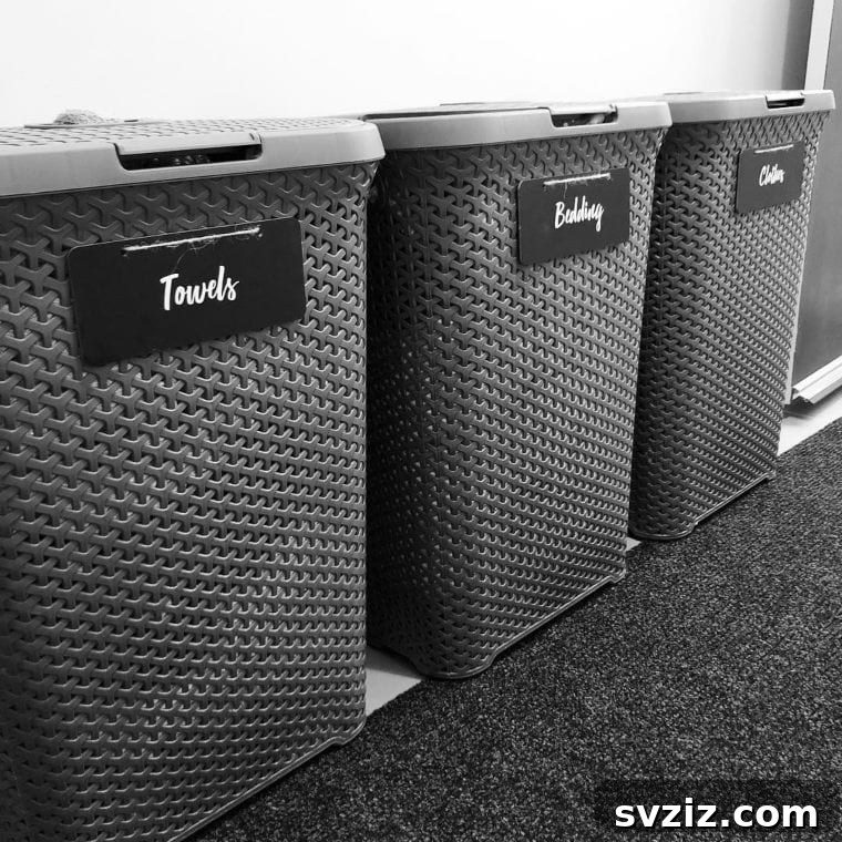 Custom vinyl labels on minimalistic laundry hampers