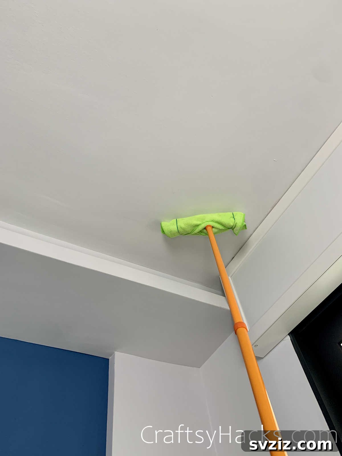 dust ceilings with a long handled duster