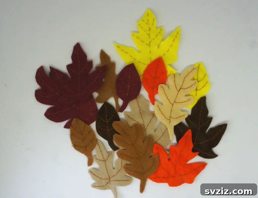 A collection of beautifully crafted felt fall leaves in various autumn colors like red, orange, and yellow, perfect for seasonal decorations.