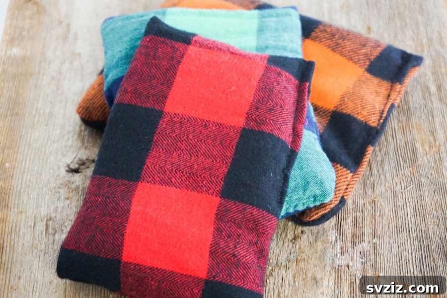 A pair of cozy DIY reusable hand warmers, featuring a soft fabric and simple stitching, perfect for cold weather comfort.