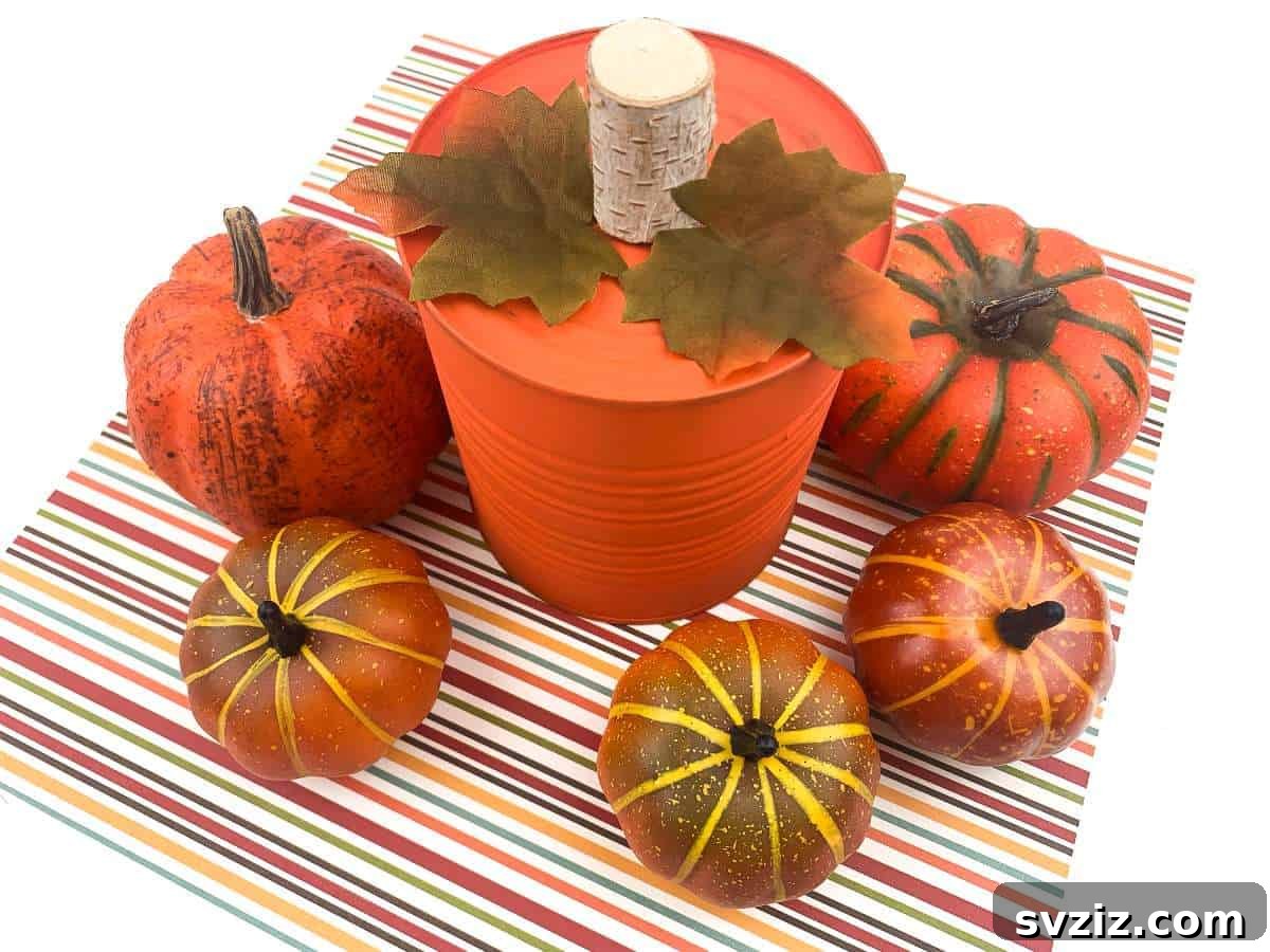 An charming upcycled tin can transformed into a farmhouse-style pumpkin, painted white and adorned with a jute stem and faux leaves.