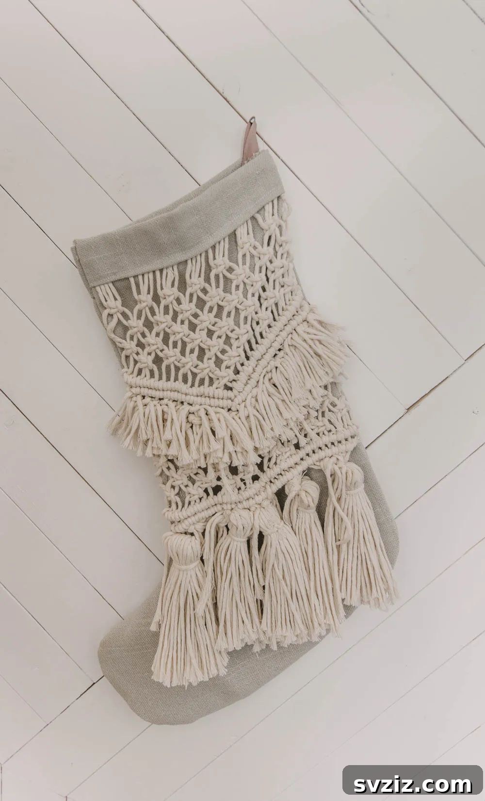 31 Festive DIYs to Deck Your Living Room This Christmas 18 Elegant macrame Christmas stocking, blending bohemian style with traditional holiday decor.