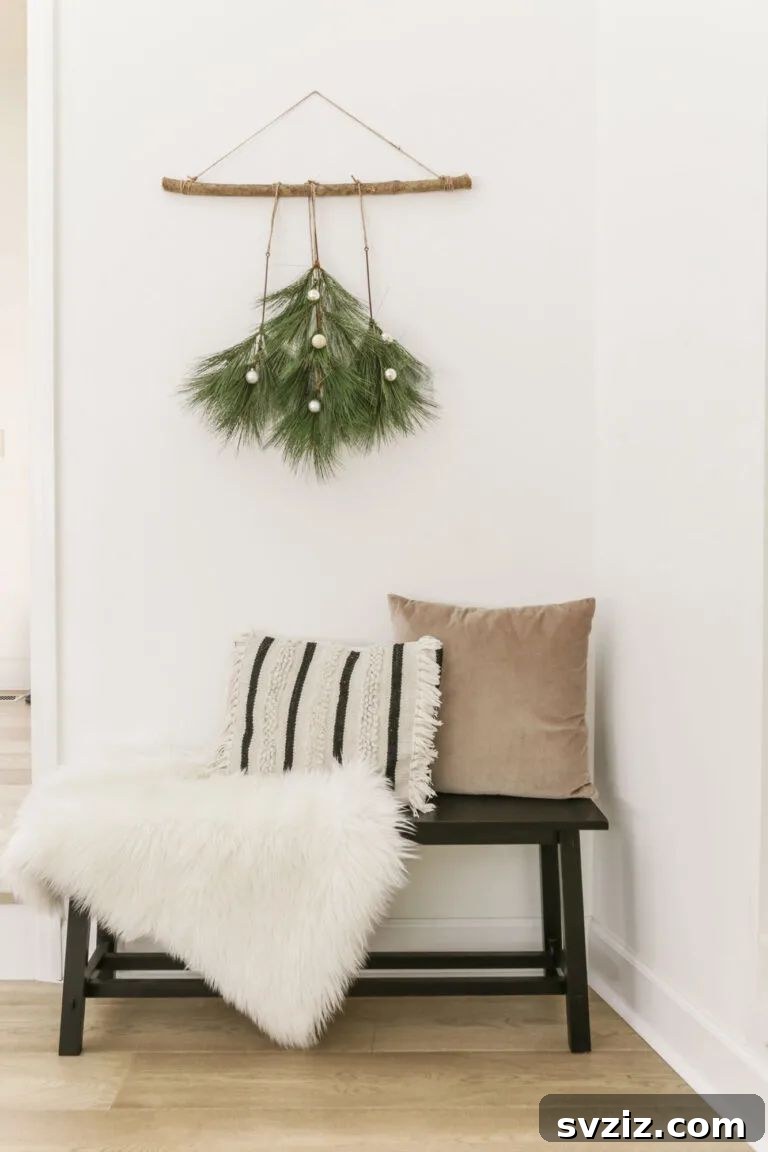31 Festive DIYs to Deck Your Living Room This Christmas 8 Minimalist boho Christmas tree wall hanging made with faux branches for modern festive decor.