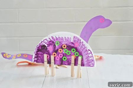 Simple paper plate dinosaur craft with green paint and cut-out features, perfect for young dinosaur enthusiasts.