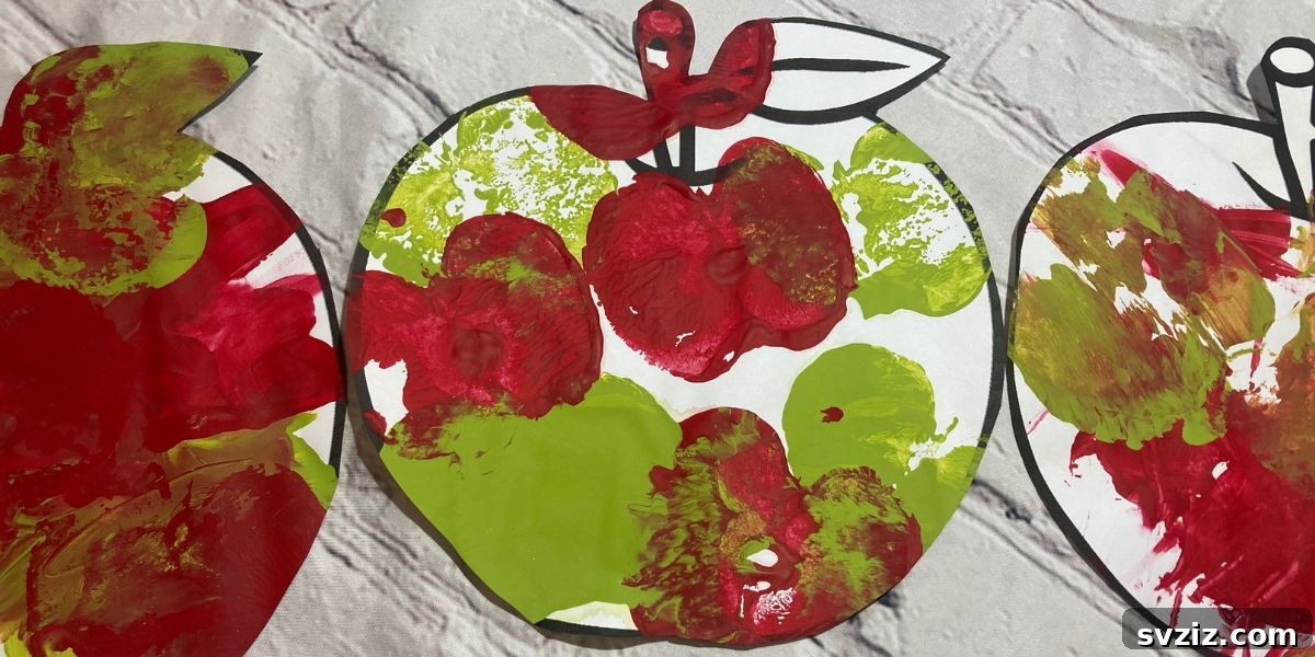 Unique apple painting craft for kids, using apple halves dipped in paint as stamps, perfect for autumn art projects.