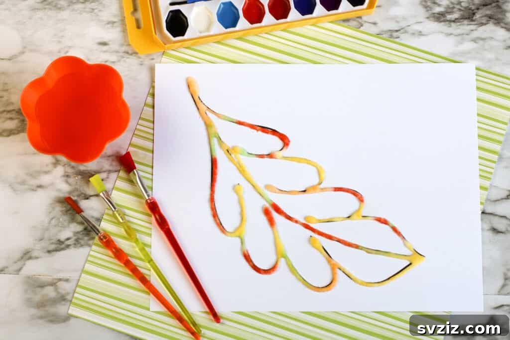 Textured painting with salt craft for kids, where glue designs are sprinkled with salt and then painted with watercolors for a unique effect.