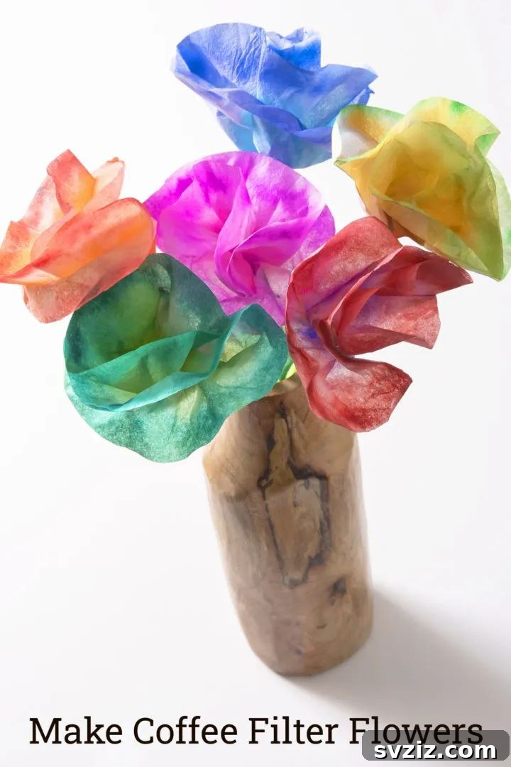 Beautiful coffee filter flowers craft, where coffee filters are colored with markers and sprayed with water to create tie-dye effects.