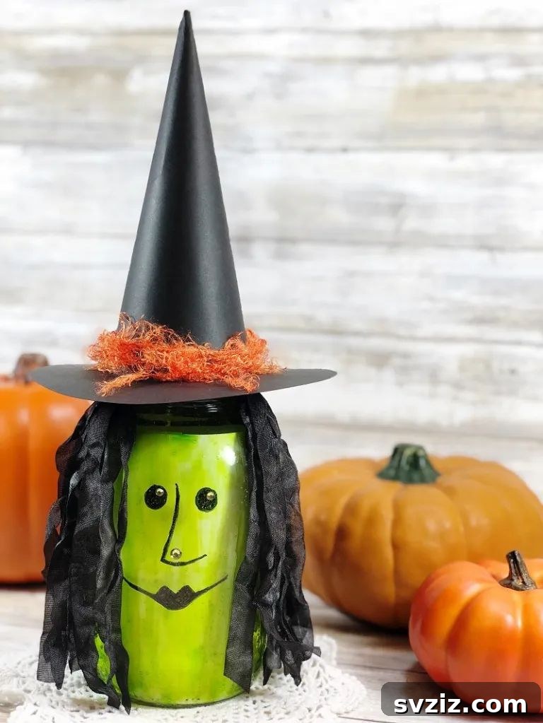 Charming and Eerie Witch Craft Projects 16 A painted mason jar witch lantern with defined features.