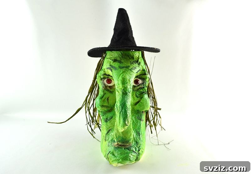 Charming and Eerie Witch Craft Projects 29 A unique witch decoration crafted from repurposed household items, including a laundry detergent bottle.