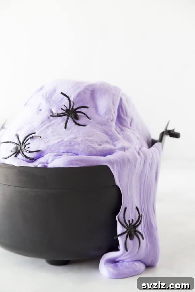 Charming and Eerie Witch Craft Projects 40 Vibrant green witches brew slime with spooky additions for kids.