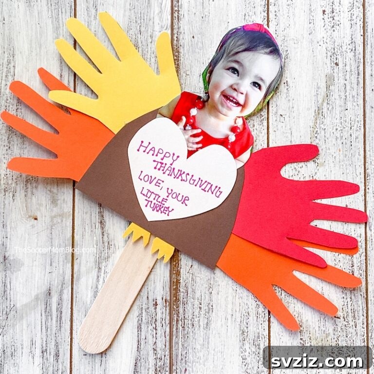 41 Simple Thanksgiving Crafts Toddlers Will Adore 8 Personalized construction paper turkey craft with child's photo and handprint feathers