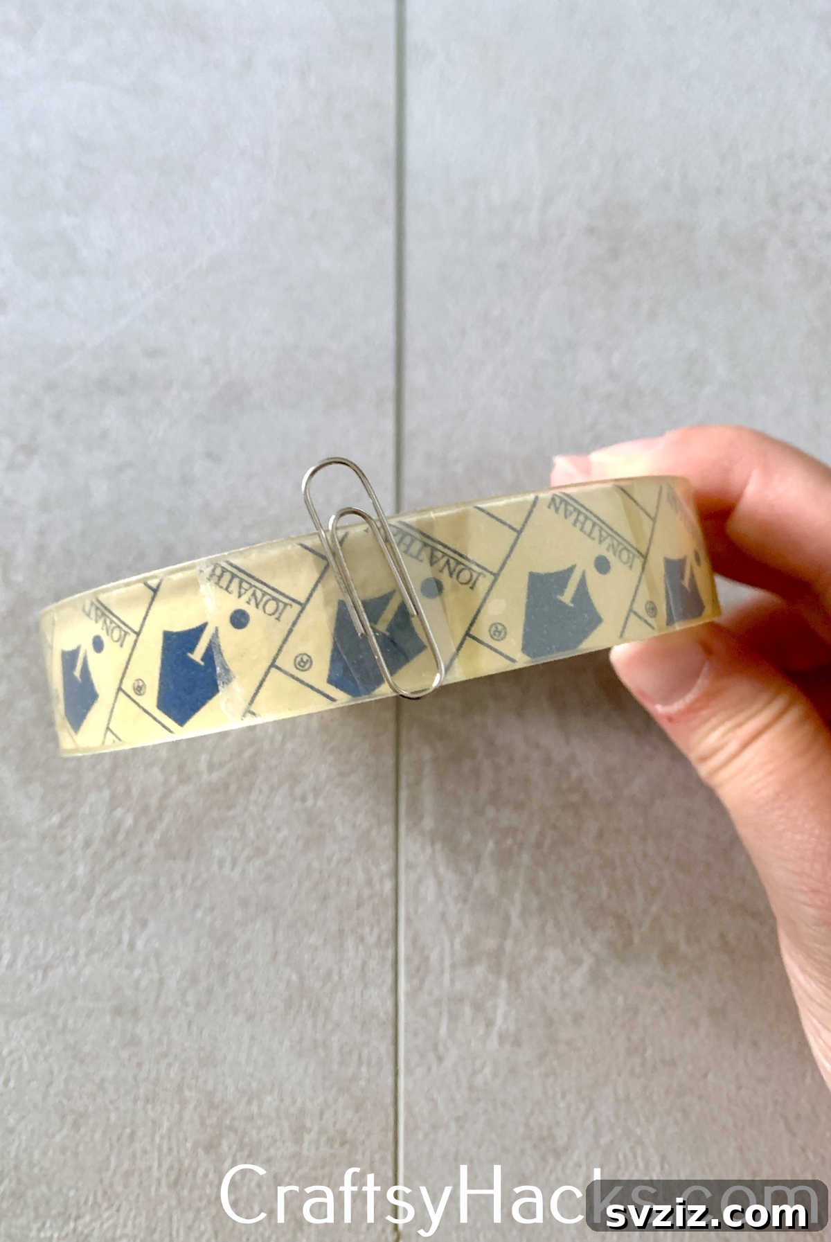 Use a paper clip to mark and easily find the end of a roll of clear tape, eliminating the frustration of searching for the tape's edge and saving time.